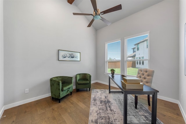 home office featuring hardwood / wood-style floors, ceiling fan, and lofted ceiling