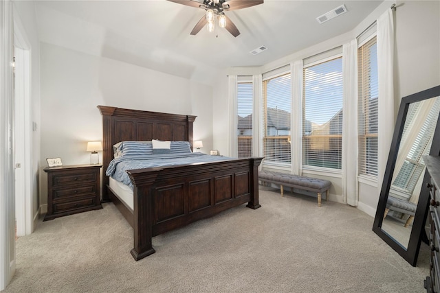 bedroom featuring ceiling fan, light carpet, and vaulted ceiling