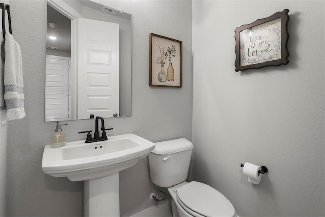 bathroom with toilet and sink