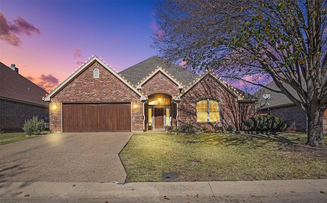 view of front facade with a yard and a garage