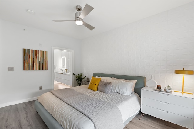 bedroom featuring connected bathroom, ceiling fan, and hardwood / wood-style floors