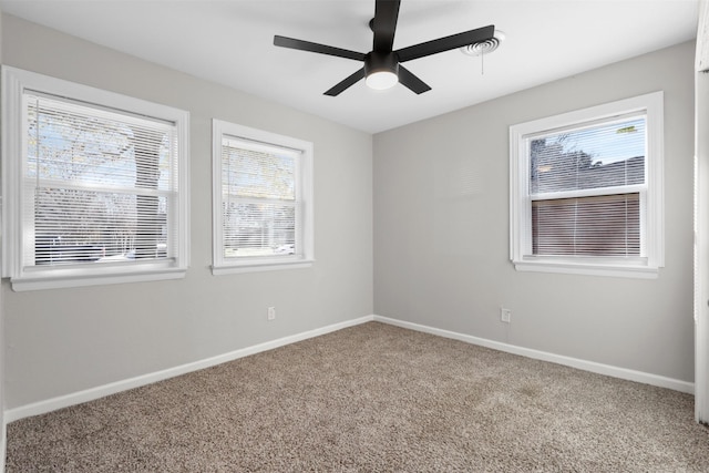 carpeted empty room featuring ceiling fan