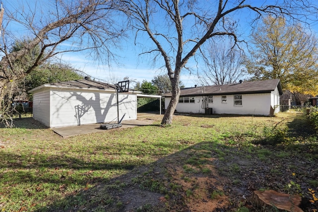 rear view of property with a lawn, cooling unit, and a patio area