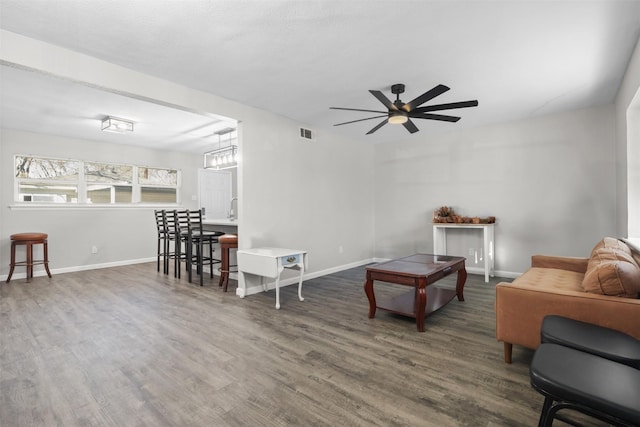 living room featuring dark hardwood / wood-style floors and ceiling fan