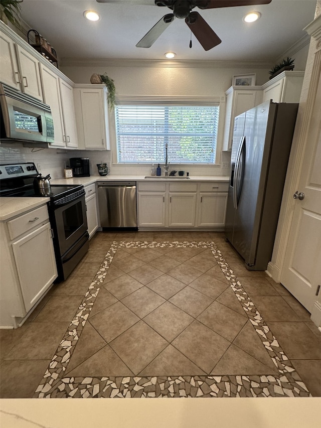 kitchen featuring white cabinets, sink, dark tile patterned floors, and stainless steel appliances