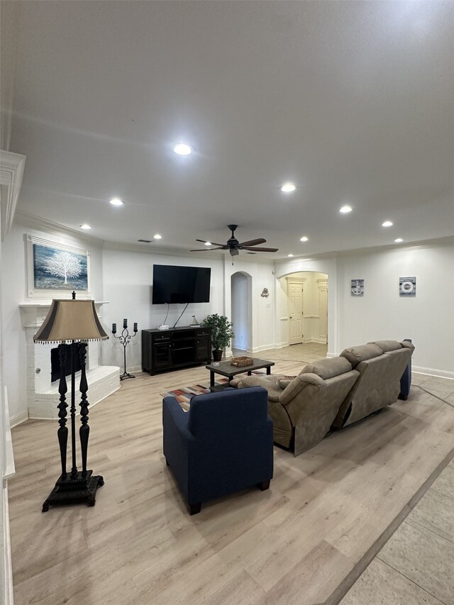 living room with light hardwood / wood-style flooring and ceiling fan