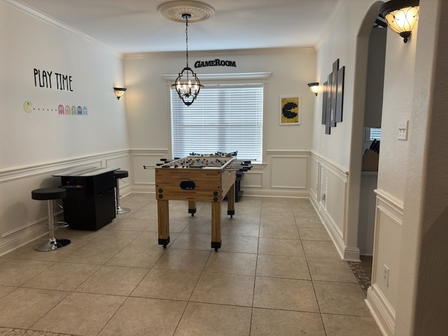 game room featuring light tile patterned flooring and ornamental molding