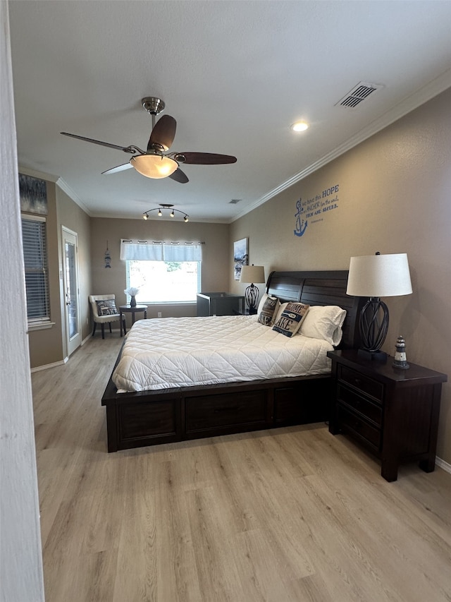 bedroom featuring ceiling fan, crown molding, and light wood-type flooring