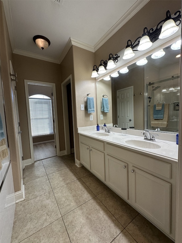 bathroom with tile patterned flooring, vanity, a shower with door, and ornamental molding