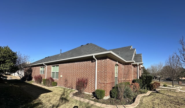 view of side of property featuring a yard