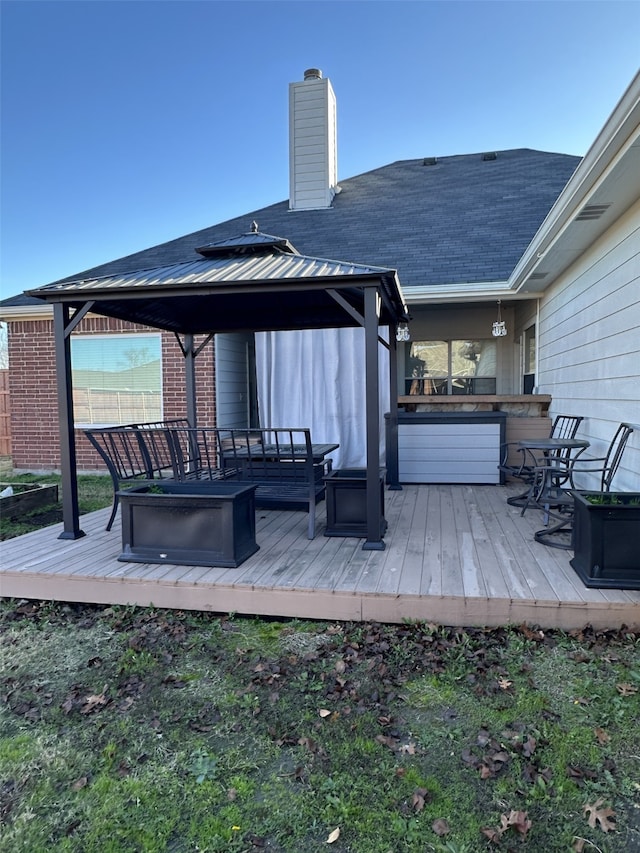 wooden terrace featuring a gazebo