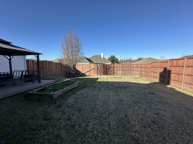 view of yard featuring a gazebo and a fenced backyard