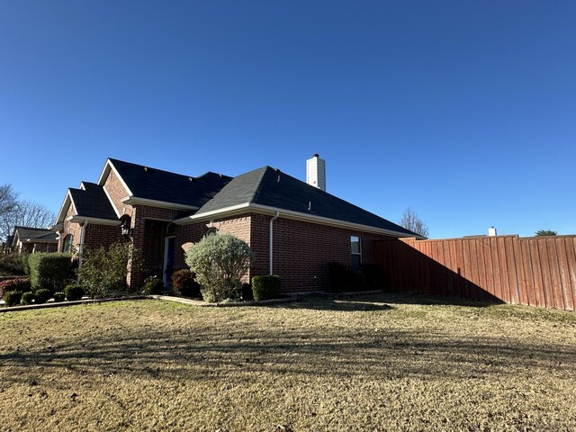 view of side of property with a lawn