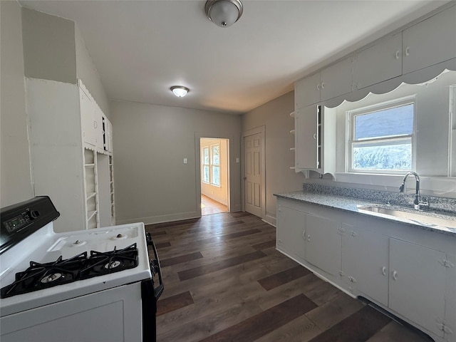 kitchen with white cabinetry, sink, a wealth of natural light, and white gas range oven