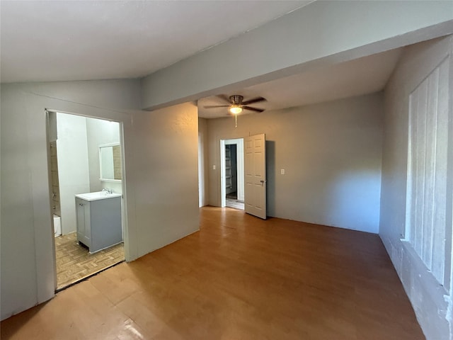 spare room featuring lofted ceiling, sink, light hardwood / wood-style flooring, and ceiling fan