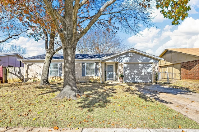 ranch-style house featuring a garage and a front lawn