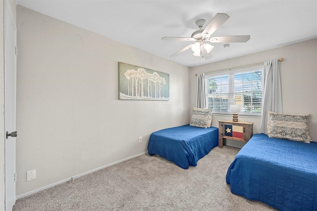 bedroom featuring light colored carpet and ceiling fan