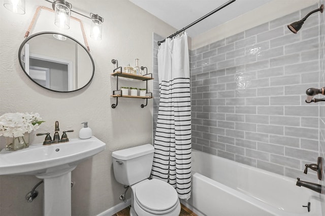 bathroom featuring shower / bath combo with shower curtain and toilet