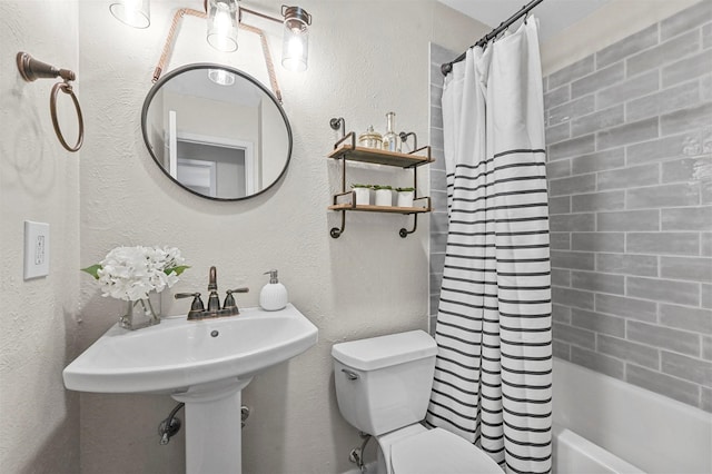 bathroom with shower / tub combo and toilet