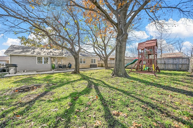 view of yard featuring a playground and a patio area