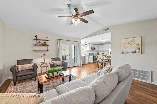 living room featuring ceiling fan, french doors, vaulted ceiling, and hardwood / wood-style flooring