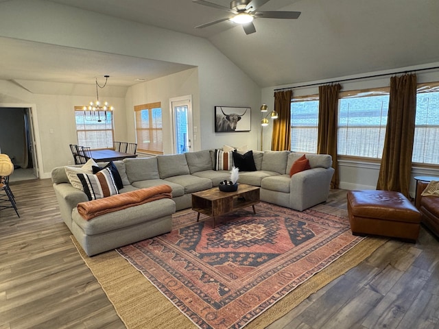 living room with lofted ceiling, hardwood / wood-style floors, and ceiling fan with notable chandelier