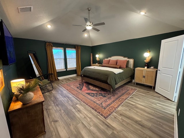 bedroom featuring hardwood / wood-style floors, ceiling fan, and lofted ceiling