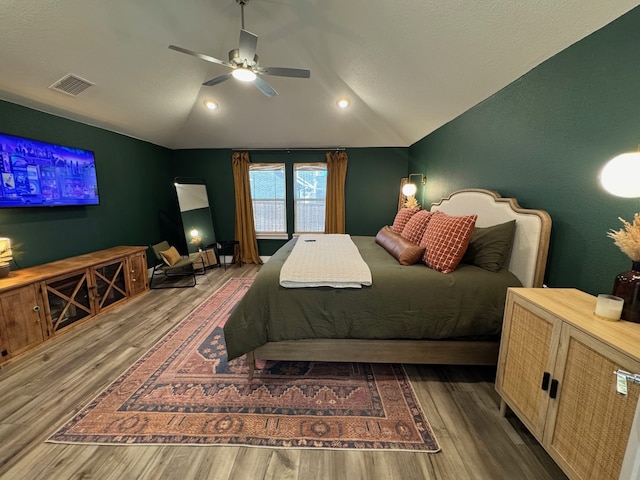 bedroom with wood-type flooring, ceiling fan, and lofted ceiling