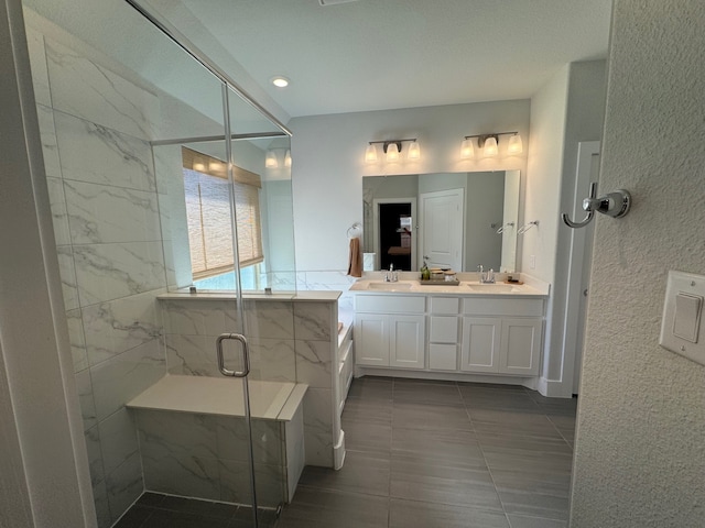 bathroom with an enclosed shower, vanity, and tile walls