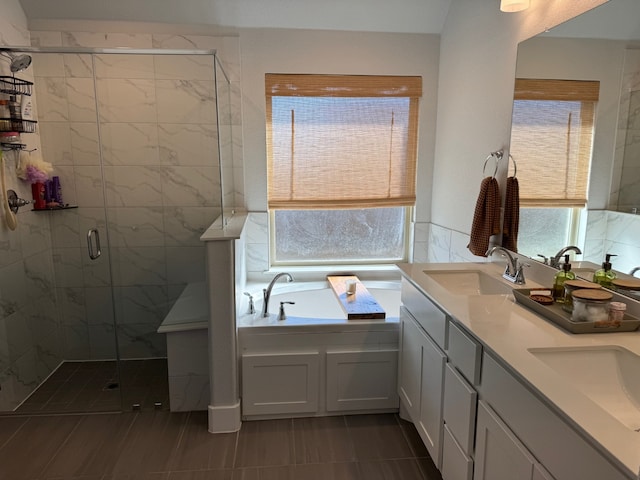 bathroom with tile patterned floors, vanity, and plus walk in shower