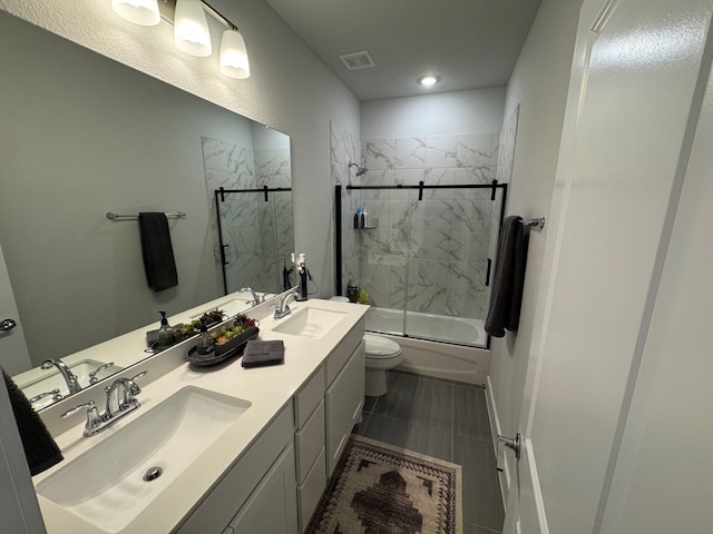 full bathroom with vanity, toilet, and bath / shower combo with glass door