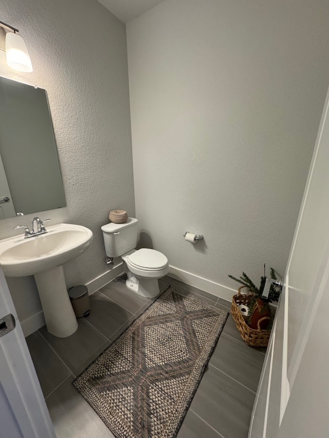 bathroom featuring tile patterned flooring and toilet