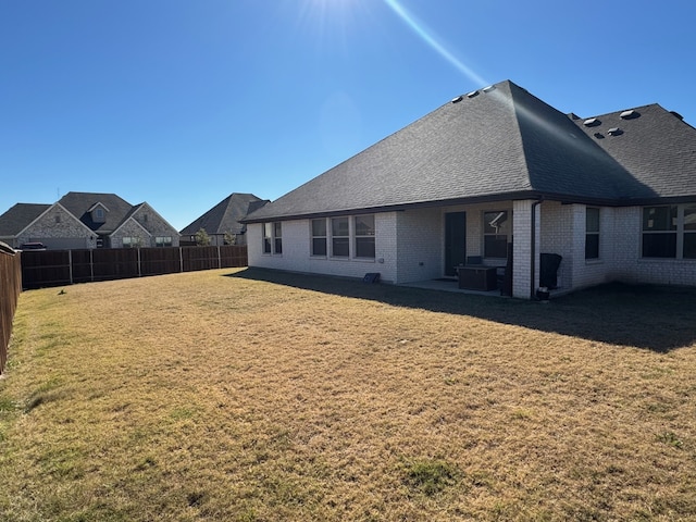 rear view of house with a lawn and a patio area