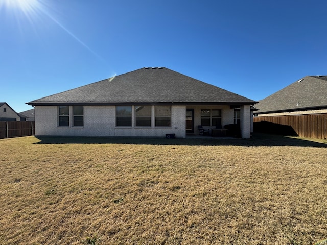 rear view of house with a yard