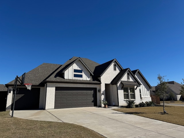 view of front of property featuring a front yard and a garage