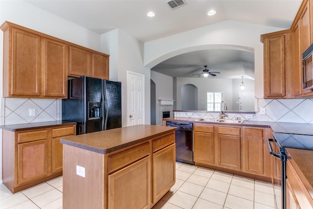 kitchen featuring light tile patterned flooring, sink, a center island, ceiling fan, and black appliances