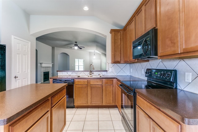 kitchen with sink, black appliances, vaulted ceiling, a kitchen island, and backsplash