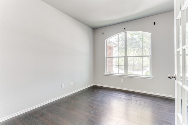 spare room featuring dark hardwood / wood-style floors and french doors