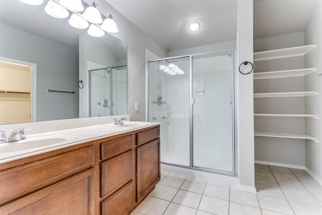 bathroom featuring vanity, a shower with shower door, tile patterned floors, and a chandelier