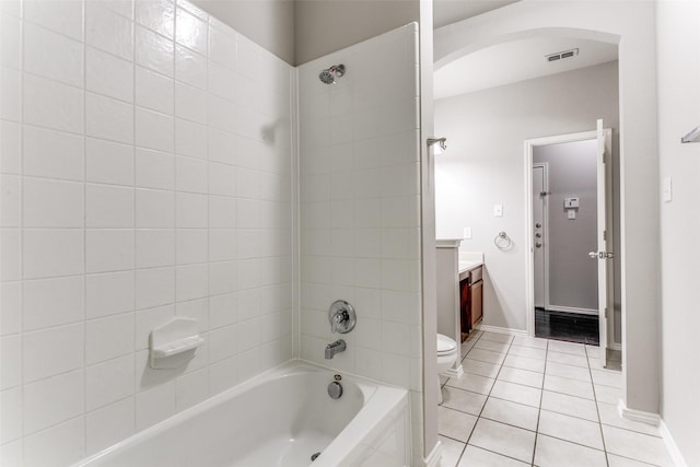 full bathroom featuring vanity, toilet, tile patterned floors, and tiled shower / bath