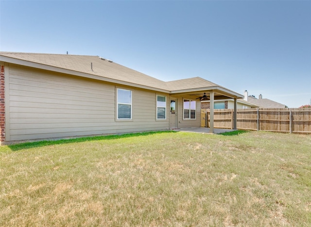 rear view of house featuring a yard and a patio area