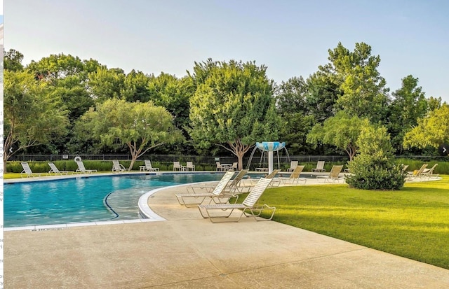 view of swimming pool featuring a lawn and a patio area