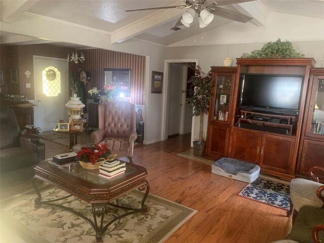 living room with vaulted ceiling with beams, ceiling fan with notable chandelier, and hardwood / wood-style flooring