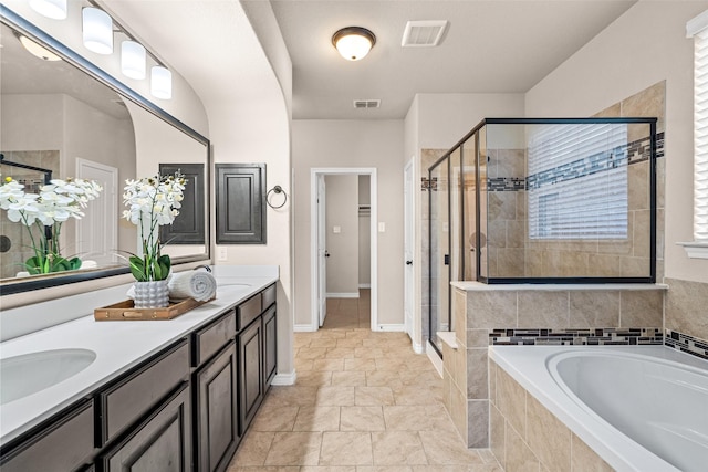 bathroom featuring separate shower and tub, vanity, and a healthy amount of sunlight