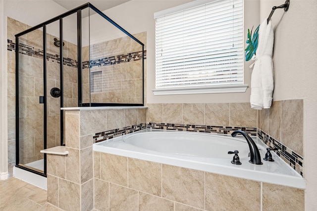 bathroom with separate shower and tub and a wealth of natural light