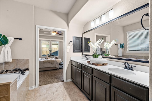 bathroom featuring tile patterned flooring, vanity, a relaxing tiled tub, and ceiling fan