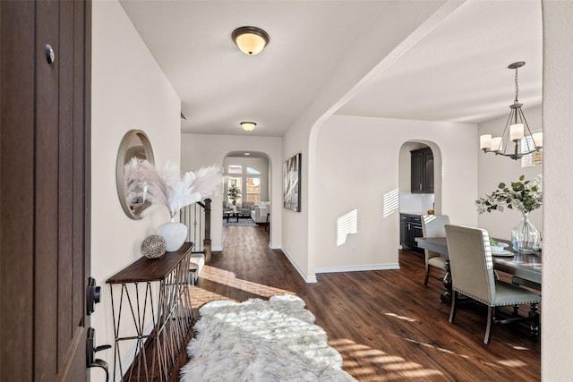 foyer with dark hardwood / wood-style flooring and an inviting chandelier