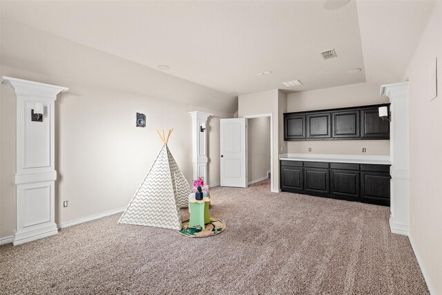 rec room with light colored carpet