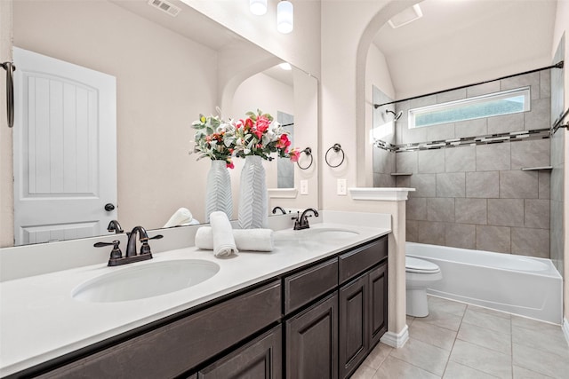 full bathroom with tile patterned floors, vanity, toilet, and tiled shower / bath