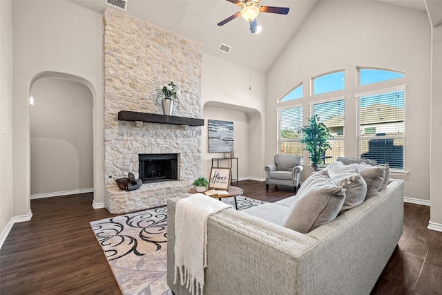 living room with ceiling fan, dark hardwood / wood-style flooring, a fireplace, and high vaulted ceiling